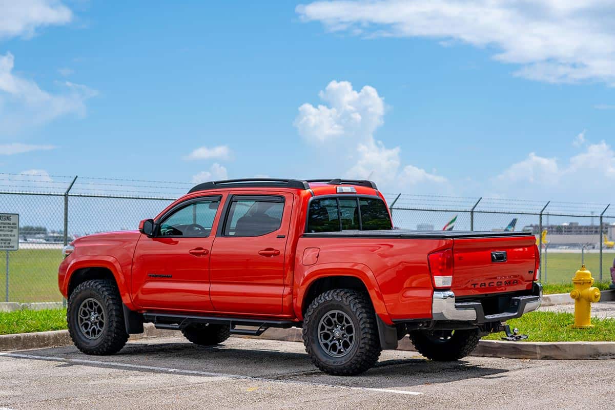 Red toyota tacoma in a parking lot