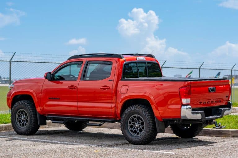 A red toyota tacoma in an empty parking lot, How To Mirror Iphone To Toyota Tacoma