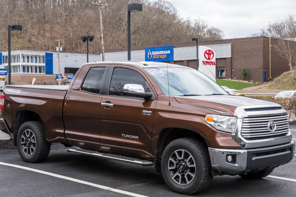 A used Toyota Tundra for sale at a dealership on a spring day. 