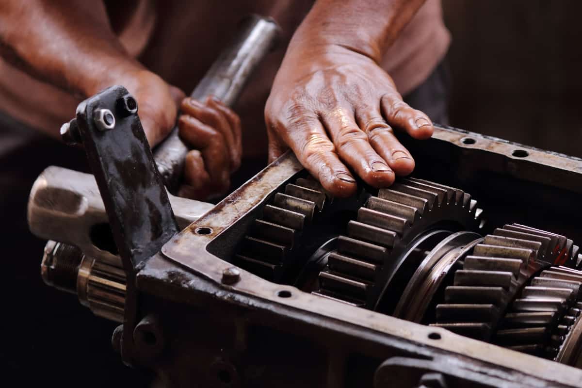 Engineer hands fixing engine power transmission gears box