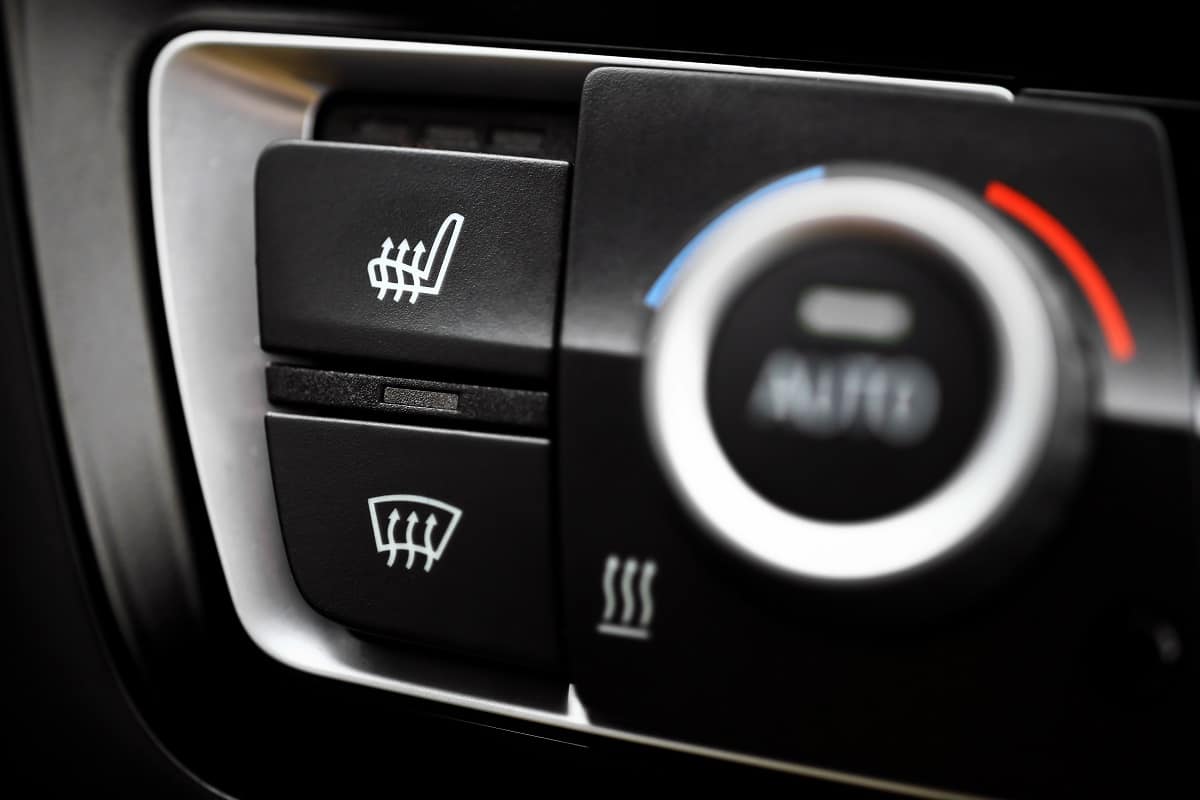 Faulty Car Heaters - Detail of the heated seats button in a car.