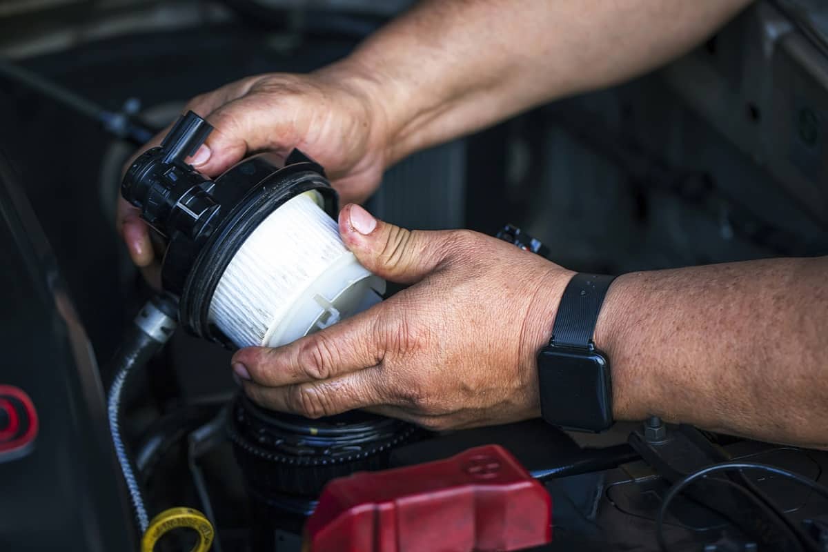 How Do You Fix A Truck’s Diesel Engine That Turned Off While Driving Car mechanic replace the new fuel filter at modern diesel engine