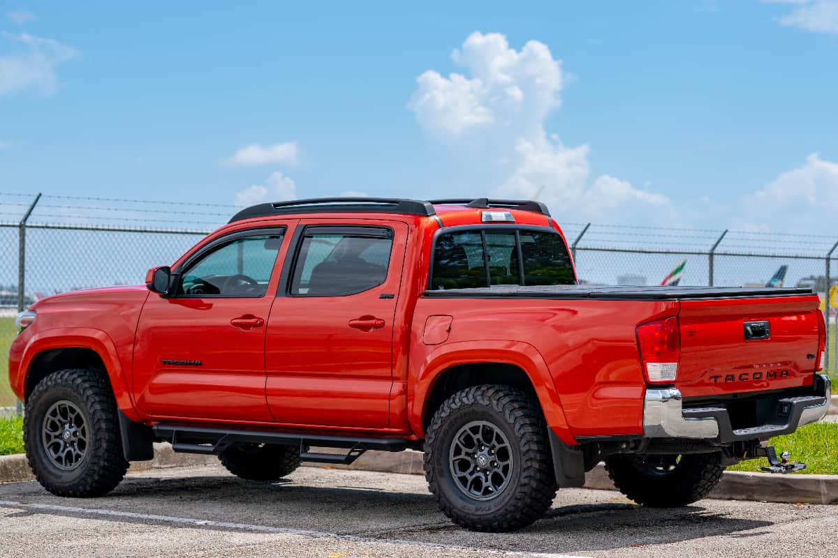 Red toyota tacoma in a parking