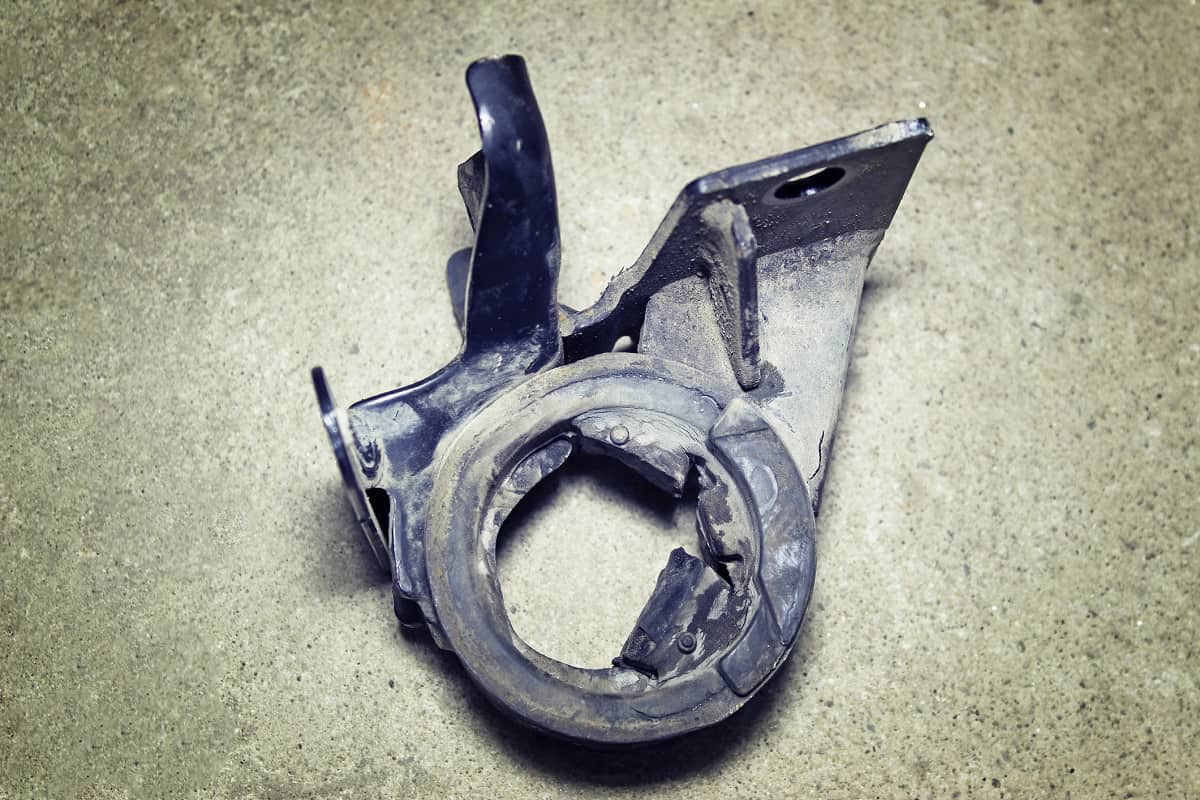 Loose Motor Mounts - The damaged engine mount on a gray background