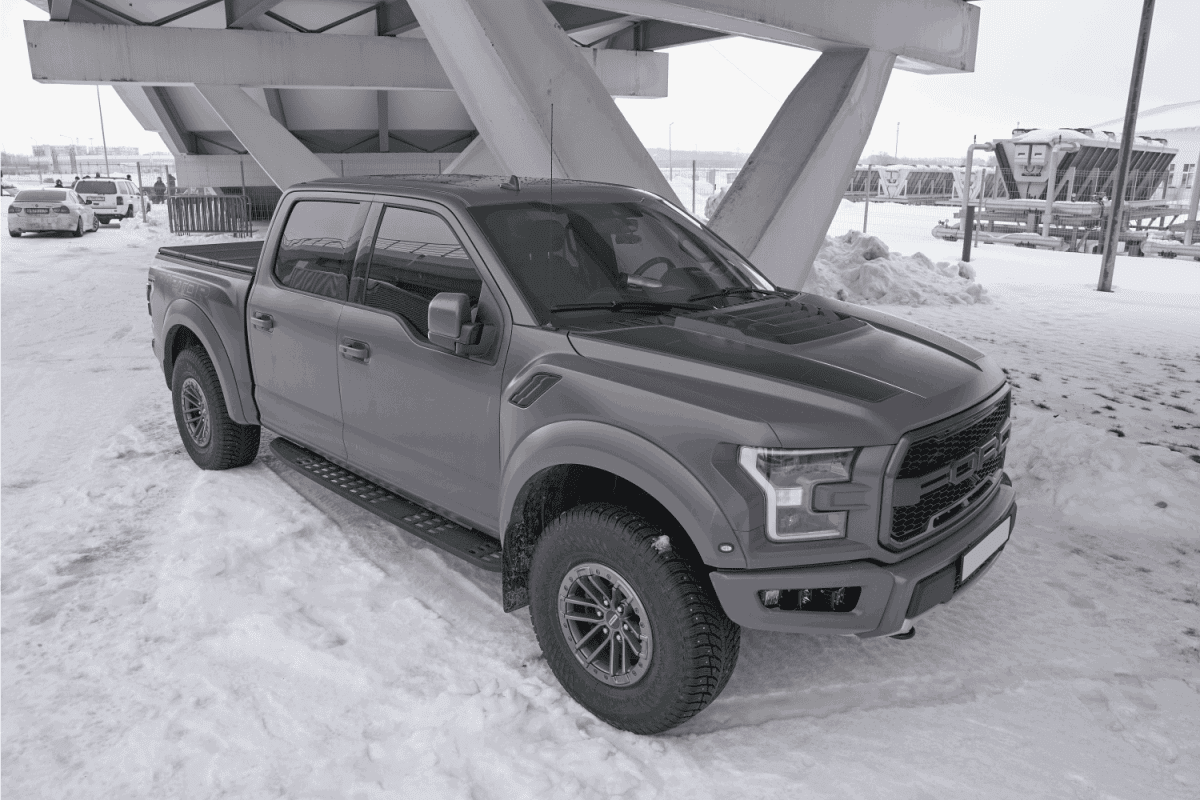gray Ford Raptor F-150 parked in winter time