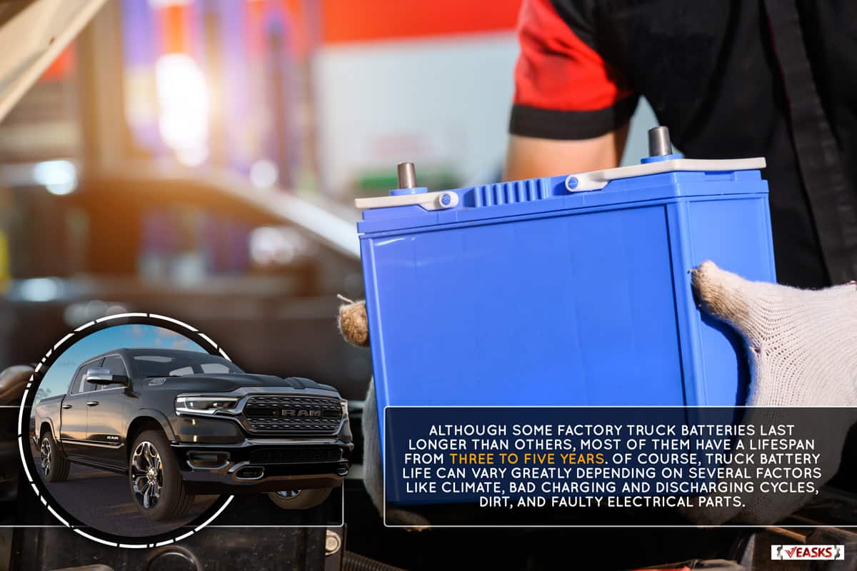 Close-up of a car mechanic in a service center picking up a new battery to replace the truck, How Long Does A Factory Truck Battery Last?