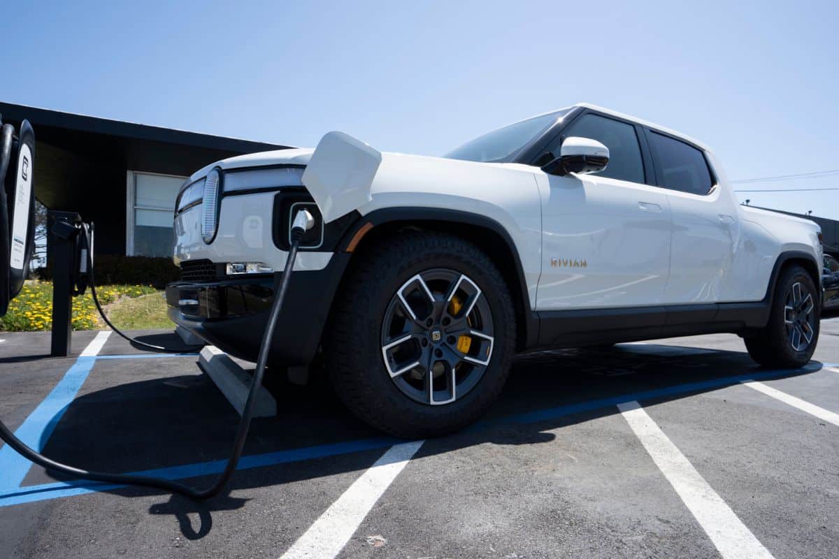  A new Rivian R1T truck is charging at a Rivian service center