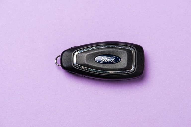 A Ford car key fob on a table, No Key Detected In Ford F-150 [Even When Key Is In Hand] - Why And What To Do?