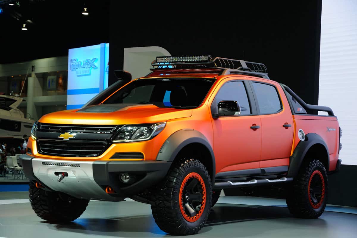 brand new orange metallic chevy colorado on the show room of 2022 cars
