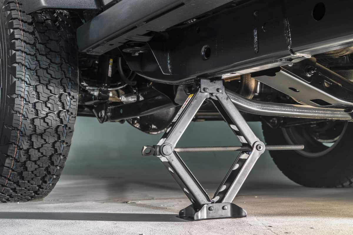 car-jack under the car chassis to lift up