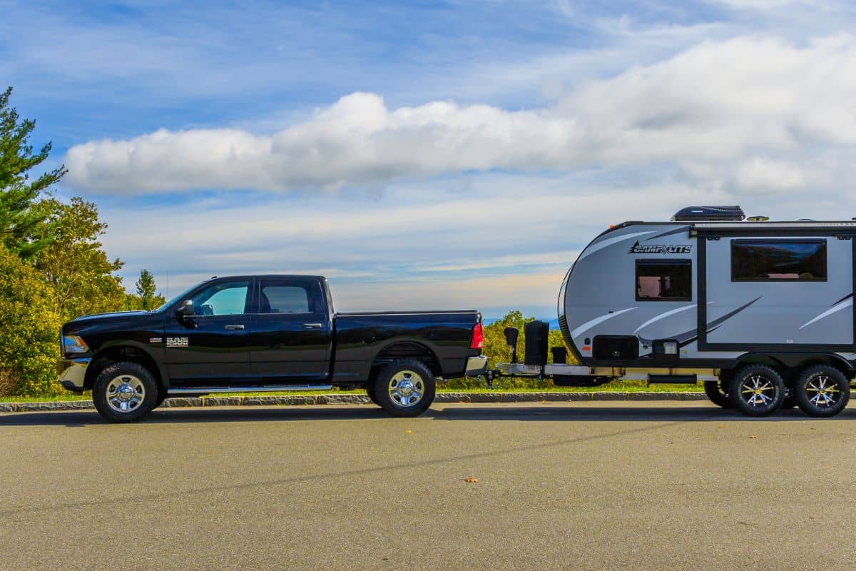 A Ram 2500 pickup towing a Camplite 16DBS travel trailer at an overlook on the Blue Ridge Parkway.