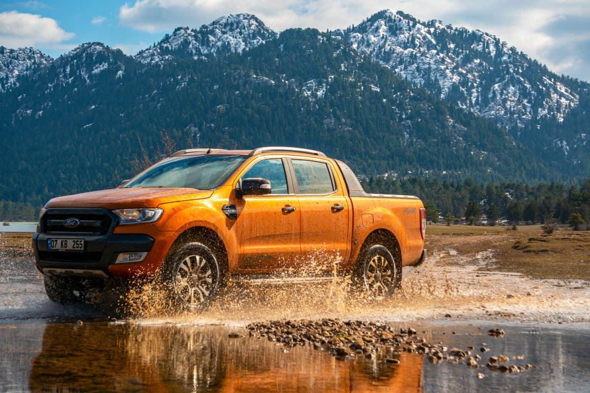 Ford Ranger pick-up truck is off roading in the mud of the river in the mountains of Antalya
