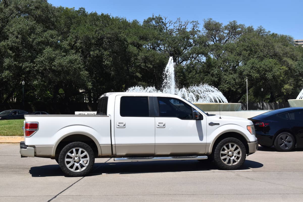 White Platinum Ford F150 parked neaar a fountain