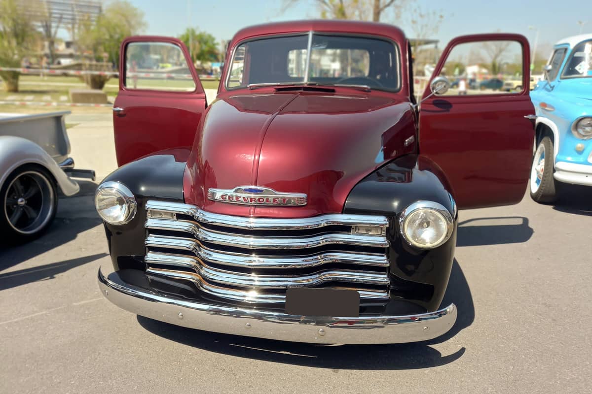 Old red and black pickup truck Chevrolet Thriftmaster 1947 by GM Doors open Utility or farming tool Front view Expo Fierros 2021 classic car show.